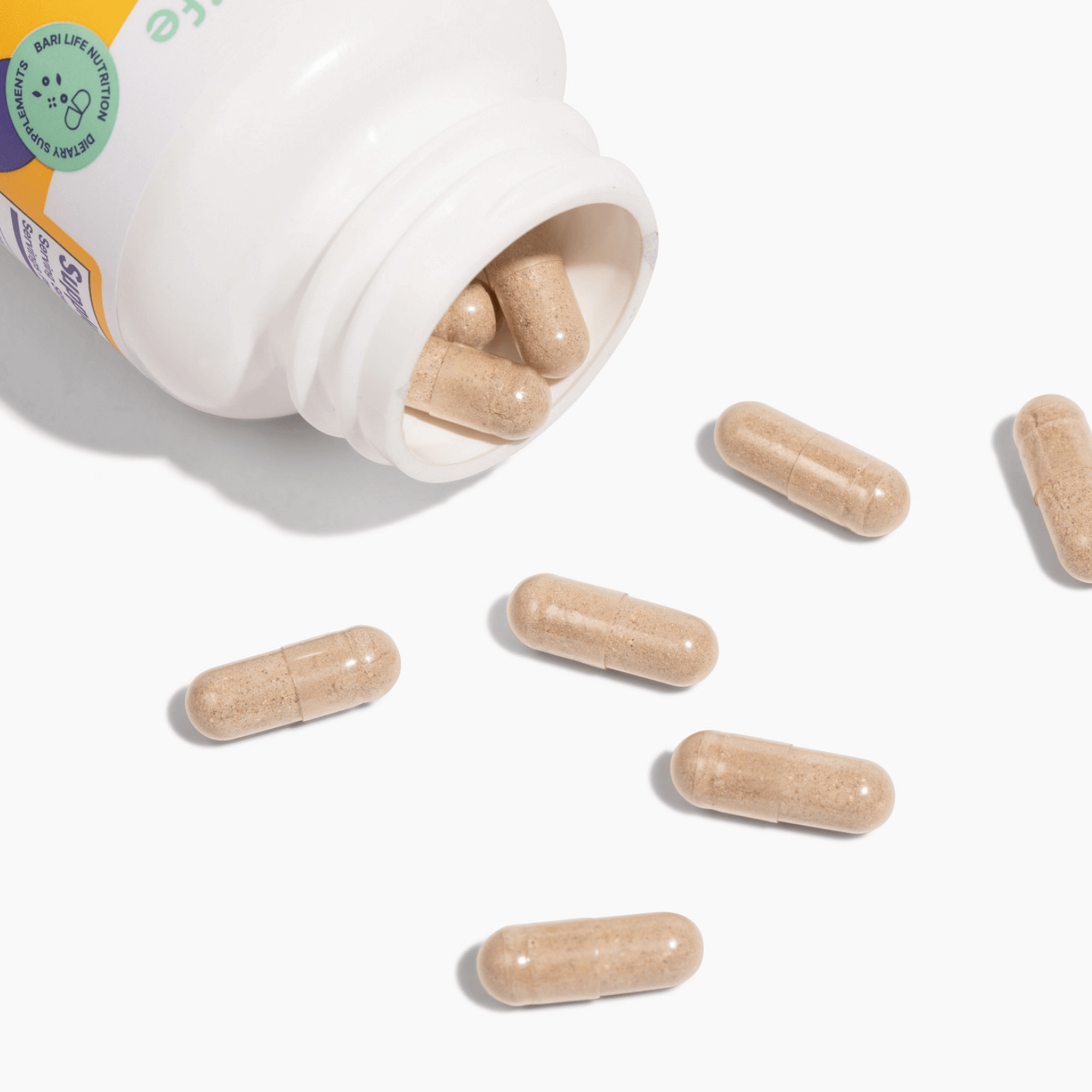Bariatric Balance Probiotic Supplement capsules spilling from a bottle on a white background.